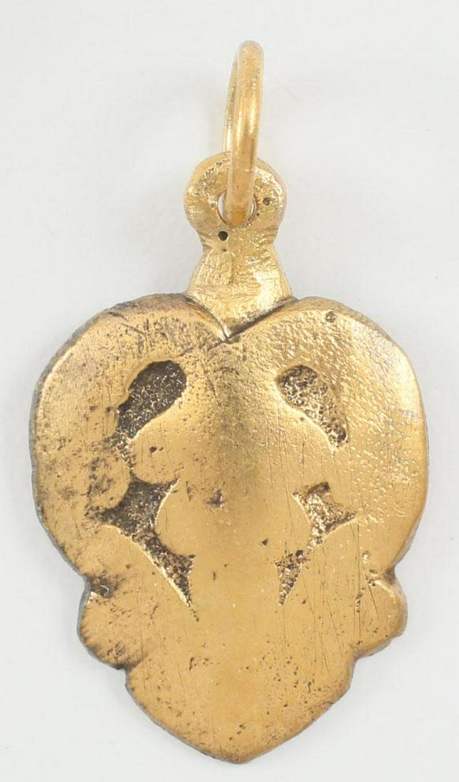 VIKING HEART PENDANT C.850-1050 AD: Just under 1” height, fully evolved form with cusped top and foliate design to the field, extending as small nubs below center. Made by the open face mold technique. For Vikings the heart stood for 