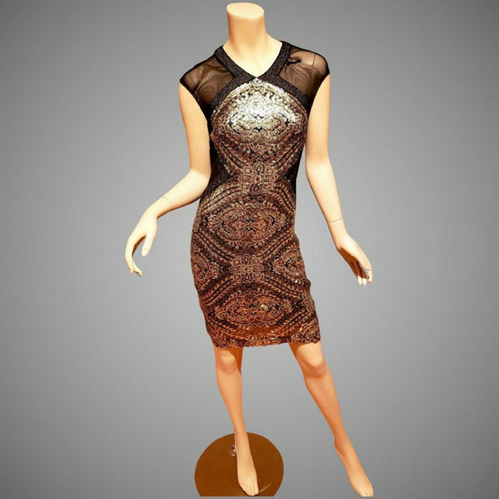 Badgley Mischka Collection Golden Eye gold sequined: Stunning gold sequins dress. The sequins are tiny and they are embroidered on a mesh lined fabric . It is a size 2 but has some stretch to it.; Bust-32"; Waist-26"; Hip-36"; This vintage item is pre-o
