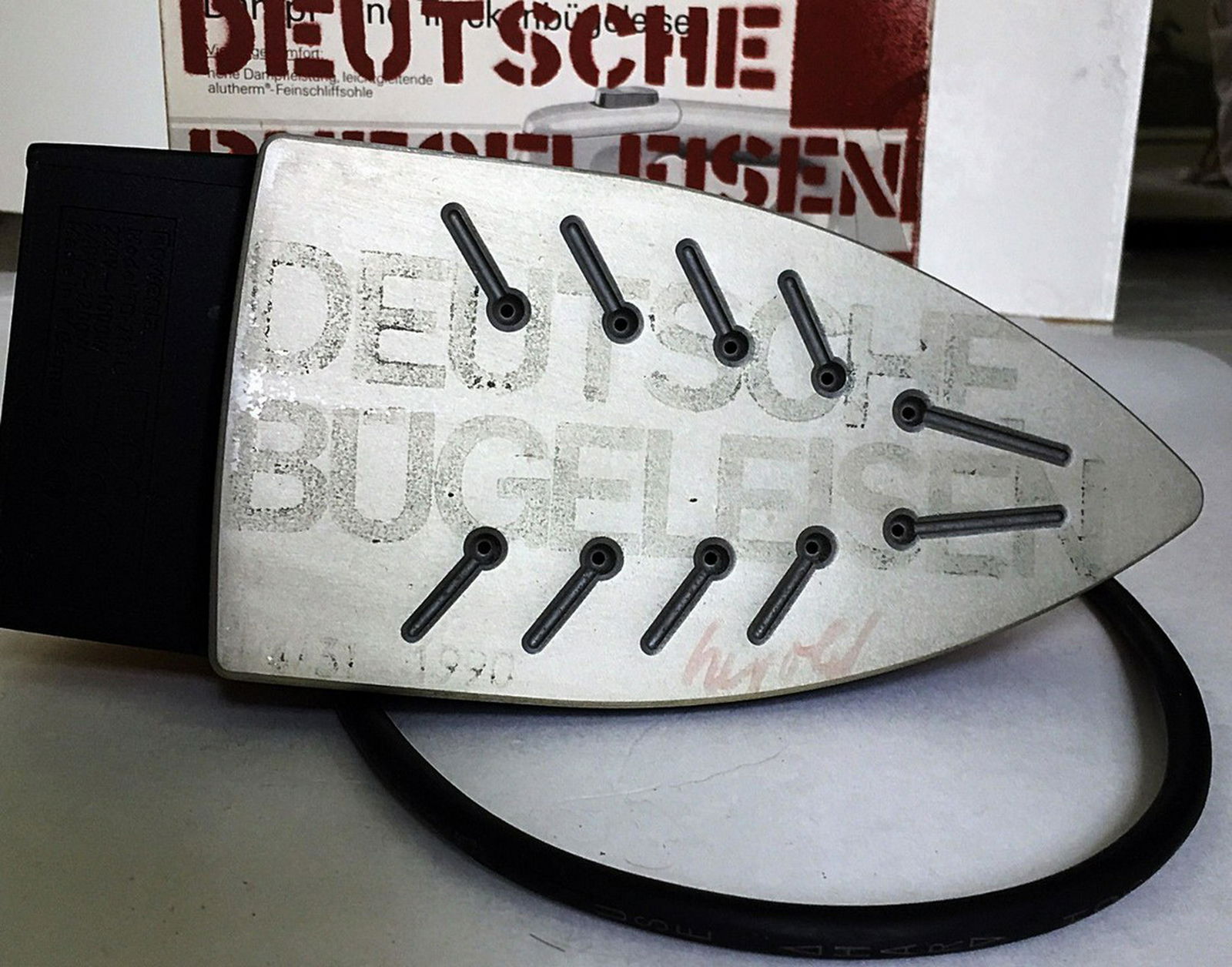 Georg Herold, Deutche Buegeleisen 1990: Artist:Georg Herold Title: Deutche Buegeleisen 1990 Medium: mixed media sculpture with paint Dimensions: 10 1/2" x 6 1/4" x 4 1/4" box, Iron is 10" x 4 1/4" x 5" Description: Stenciled Box and Iron, a