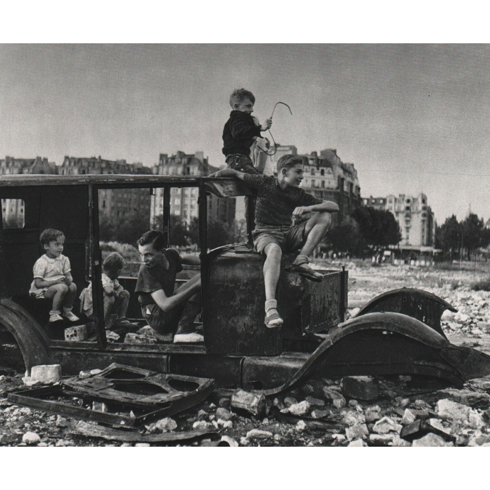 ROBERT DOISNEAU - Used Car, 1944: Artist: ROBERT DOISNEAU Print Title: Used Car, 1944 Medium: Sheet-fed Gravure Printing Date: 1970's Printed in France Image Size: 7 x 5.5 inches Robert Doisneau (1912-1994) was a French photographer.