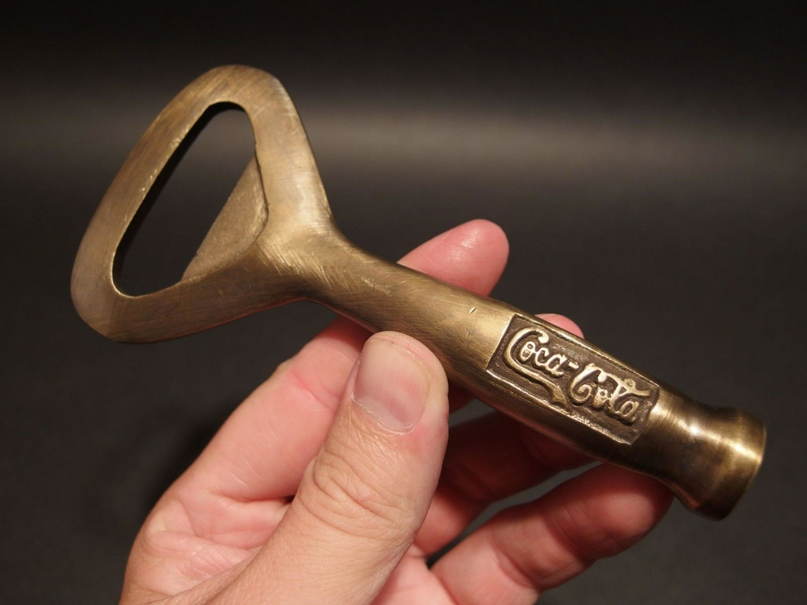 Brass Coca Cola Soda Beer Bottle Cap Opener: 5 1/8" Long x 2 1/2" Wide Great reproduction heavy solid brass bottle opener. This piece was made to look just like an antique, but is actually new. Nicely made all solid brass... Great for use or dis