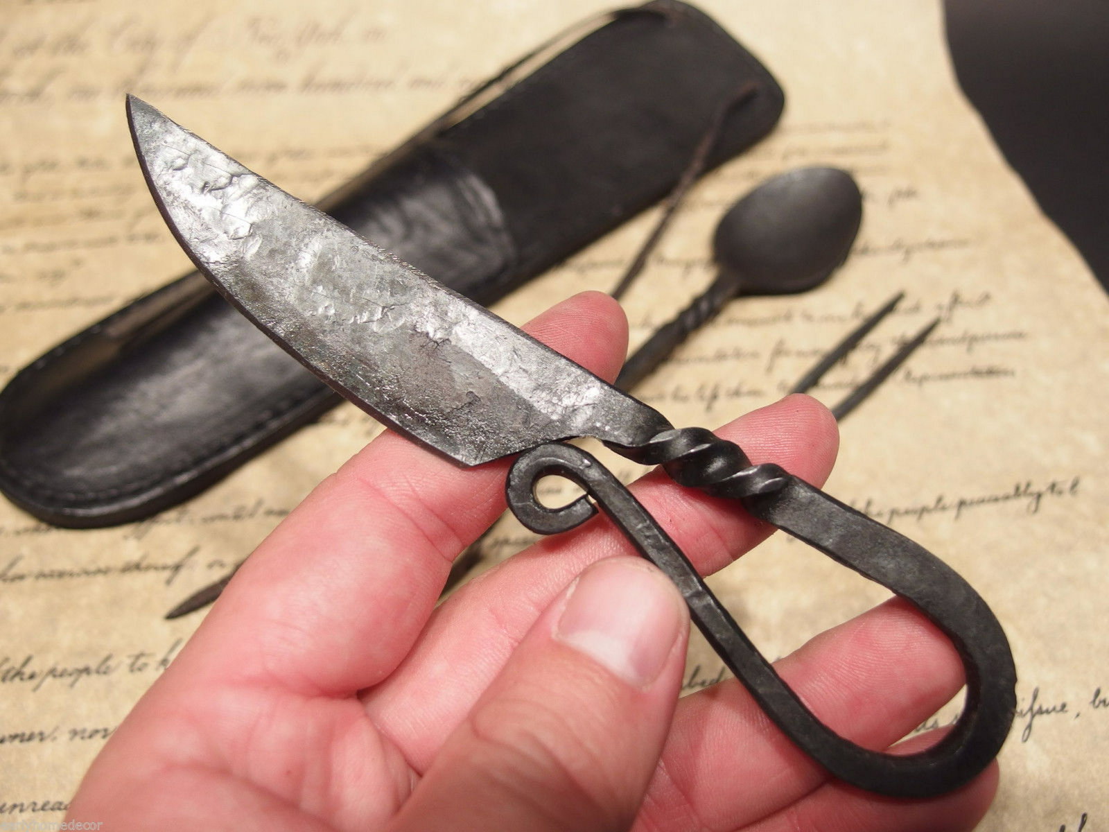 Flint Striker Style Custom Forged Primitive Knife: 10 1/4" Long x 2 5/8" Wide Knife 6" L 1 7/8" Wide Fork 6 3/4" Long Spoon 7 1/2" Nice hand made flint striker style knife. As you can see the talented craftsman curled the handle into the shape of an a