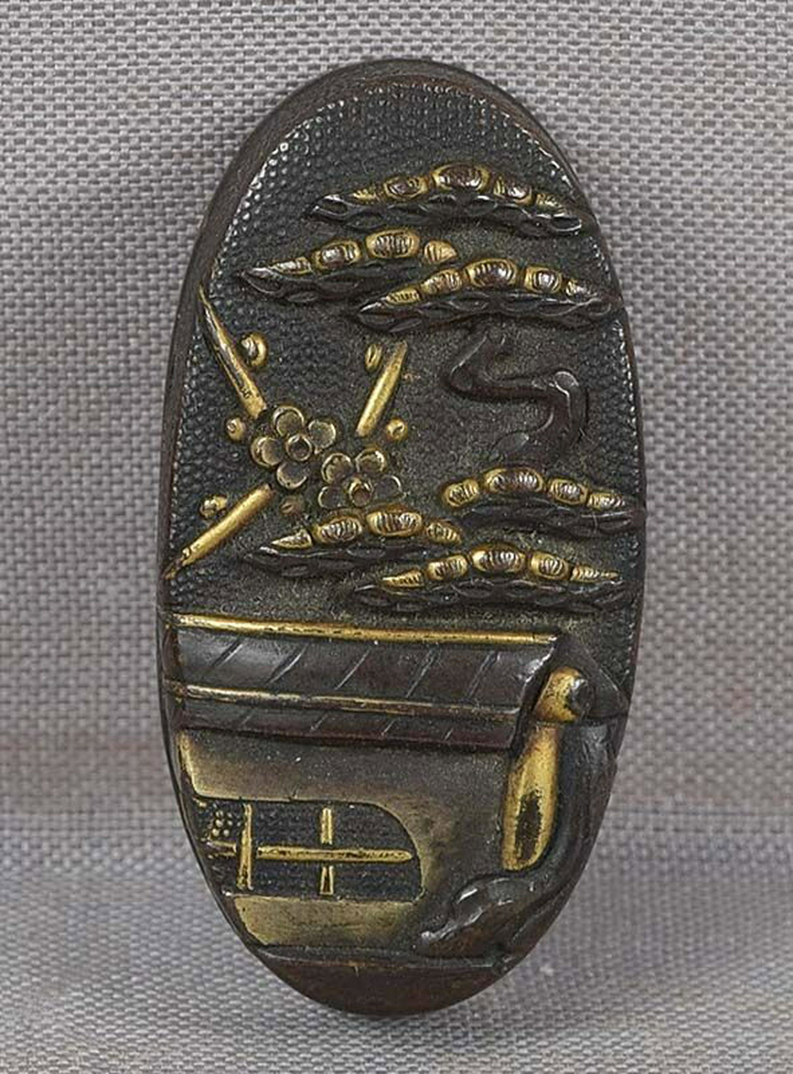 19c Japanese sword KASHIRA PALACE with pine & cherry: 19th century Edo period Japanese kashira (metal pommel at the end of the hilt of a sword) with multimetal inlays depicting a palace roof under a gnarled pine tree and flowering cherry, all on a punche