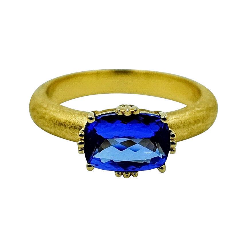 Luca Jouel Tanzanite Dress Ring in 18 Carat Yellow Gold: Mazarine - This gorgeous 18ct yellow gold ring is set with a beautiful tanzanite in an elegant chenier setting. The band has been custom hand matte finished. 1 x oval faceted Tanzanite: medium to dark