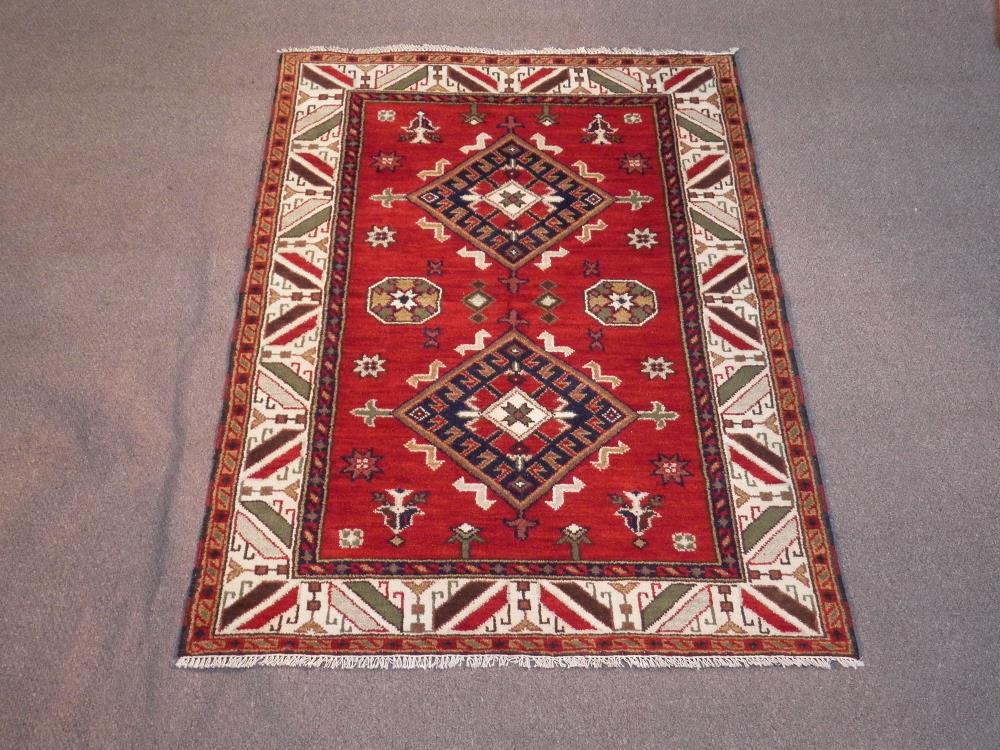 Highly Collectible Handmade Kazak Design 4.8x6.6: Title: Highly Collectible Handmade Kazak Design 4.8x6.6 Description: Hand Woven Kazak Design rug. Made of fine quality wool pile on cotton foundation, all natural vegetable dye. Size 4.8 x 6.6 feet. H