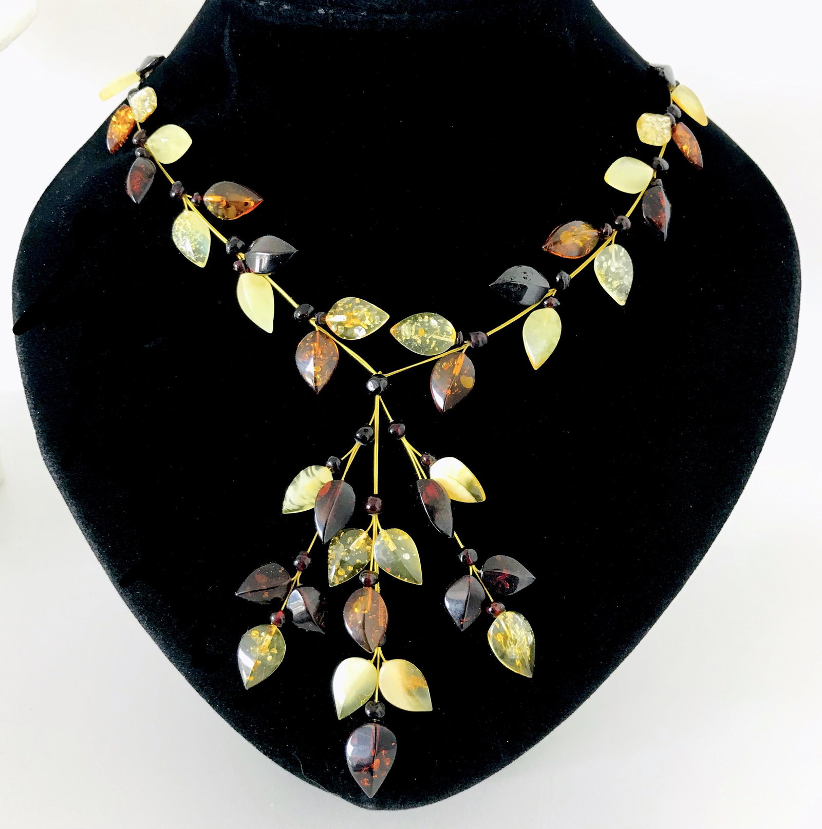Exclusive hand carved Amber necklace: Title: Exclusive hand carved Amber necklace Gemstones: Baltic Amber Weight: 12 gr Size: length 46 cm, pendant 7cm Additional Information: amber in colours of lemon, honey, cognac and cherry Reserve: $