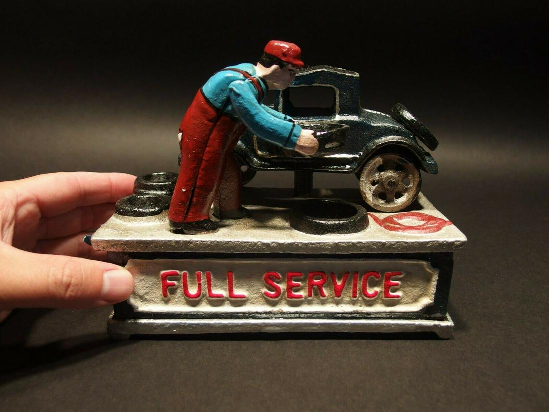 Cast Iron "Full Service" Mechanical Coin Bank Toy: 7" Long x 5 3/4" Tall x 3 1/2" wide 6 lbs A wonderful reproduction cast iron collectible mechanical coin bank. All hand painted. This cast iron toy as you can see operates by pushing down the lever. I