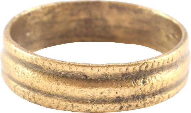 ANCIENT VIKING WOMAN’S WEDDING RING C.850-1050 AD SIZE: Gilt bronze. 4.7mm width, comprised of three raised rounded ridges, each hand stippled overall. The inside showing tool finishes from having been cast with a core, later removed for finishing and wear