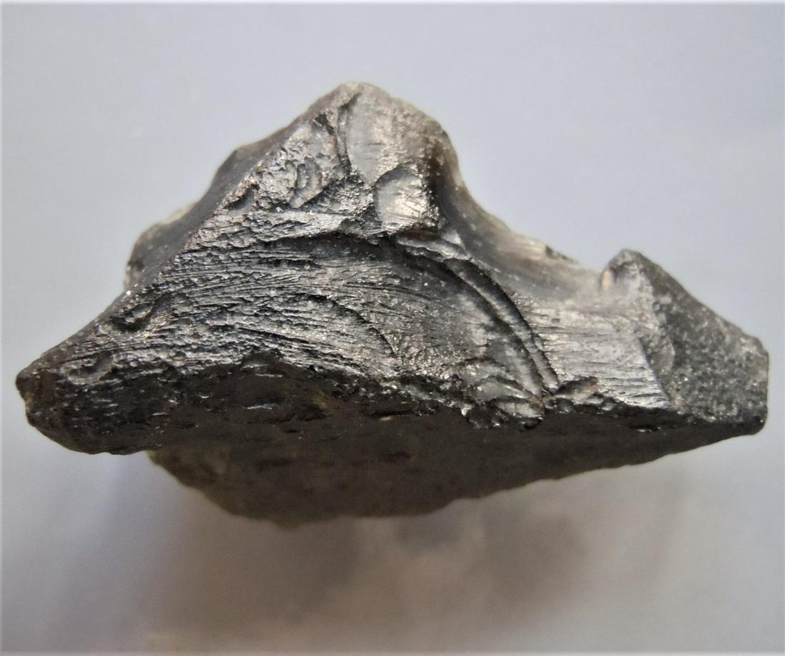 THAILANDITE TEKTITE - FROM METEORITE IMPACT: Title: THAILANDITE TEKTITE - FROM METEORITE IMPACT Origin: Noen Sa-nga. Chaiyaphum Prov. Thailand Size: 2.4x1.5x0.85 / 3 gram Description: triangular, wedge shaped thailandite tektite with interesting