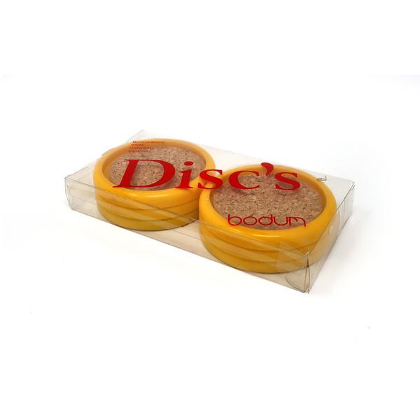 Vintage Yellow Bodum Cork Coasters: Made in Switzerland, these vintage cork and plastic coasters by Bodum add a fun pop of yellow to any coffee table. In original packaging. 6.5” x 3.25” x 1” Reserve: $35.00 Shipping: Domestic: Fl