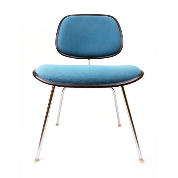 Vintage Teal Upholstered DCM Chairs by Eames for Herman: A vintage upholstered EC-127 DCM chairs by Ray and Charles Eames for Herman Miller. Molded plastic seats and backs with a lovely teal upholstery, black piping around the seat and back, chrome legs, an