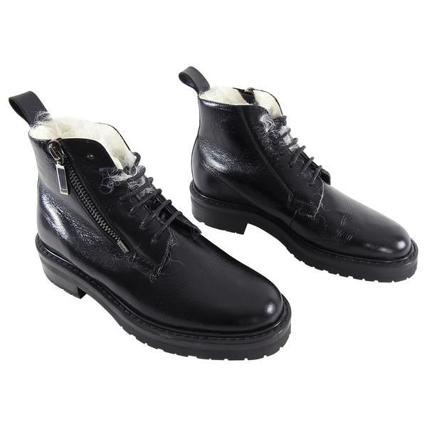 Saint Laurent Black Shearling Lined William Combat: Saint Laurent Black Shearling Lined William Combat Boots. Black glossed leather with rubber track sole and white curly lamb shearling lined interior. Metal side zipper and lace up front design. Marked