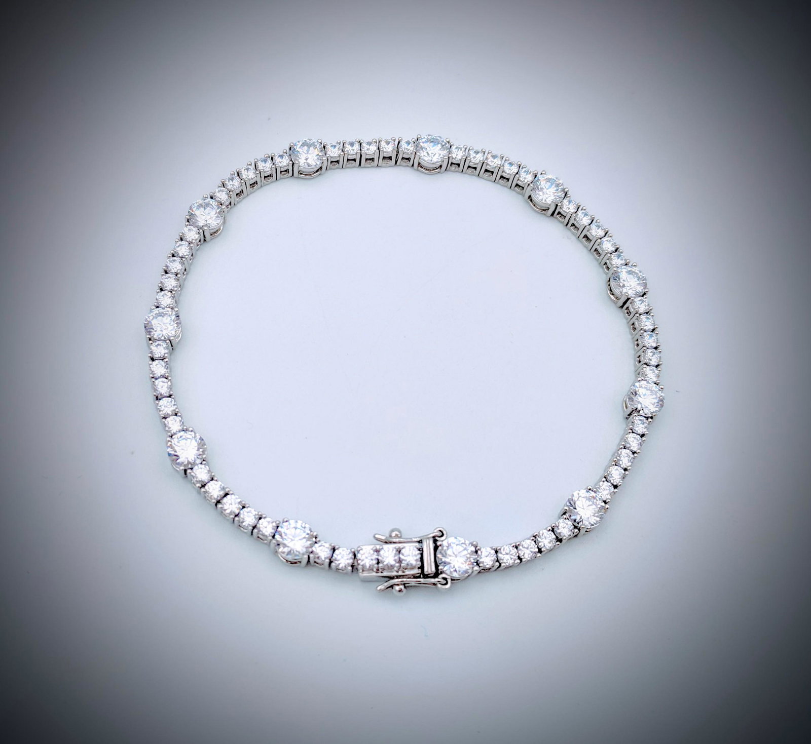Sterling Silver Tennis Bracelet w Cubic Zirconia: Title: Sterling Silver Tennis Bracelet w Cubic Zirconia Brand: Jean Lin Collection Metal Purity: 925 Sterling Silver Gemstones: Cubic Zirconia Carat Weights: Bracelet has 11 Round Cubic Zirconia at 5m