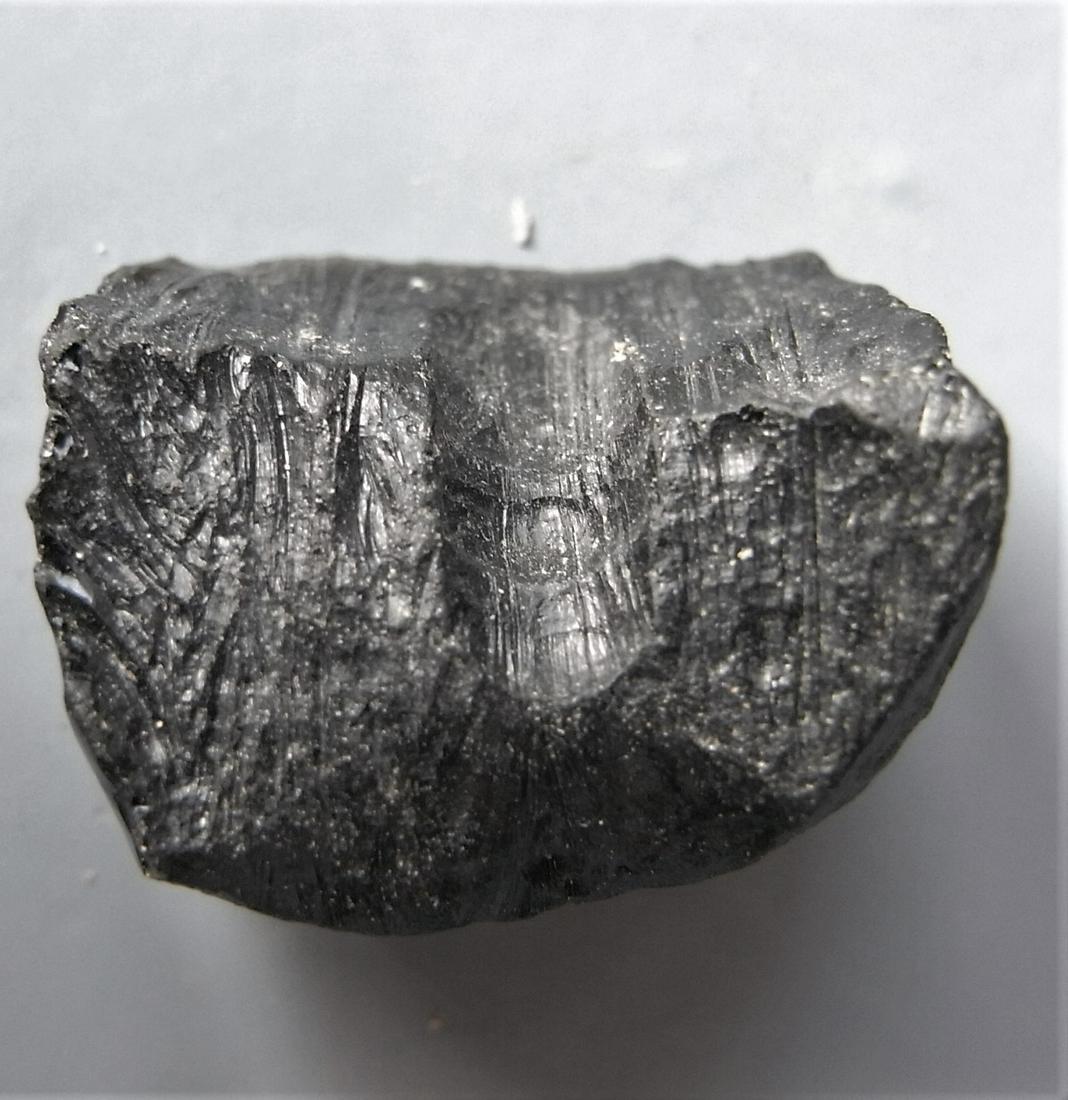 THAILANDITE TEKTITE - FROM METEORITE IMPACT: Title: THAILANDITE TEKTITE - FROM METEORITE IMPACT Origin: Noen Sa-nga. Chaiyaphum Prov. Thailand Size: 1.9x1.3x0.9 cm / 4 gram rectangular, blocky thailandite tektite with broad goove. other sides sm