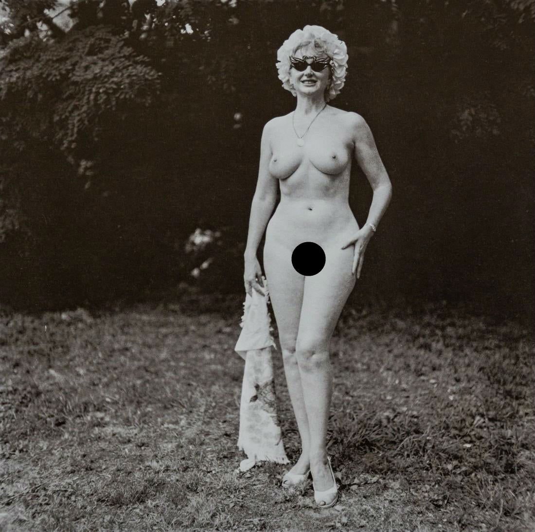 DIANE ARBUS - Nudist Lady with Swan Sunglasses, PA: Artist: Diane Arbus Title: Nudist Lady with Swan Sunglasses, PA, 1965 Medium: Photo Litho, 1972, USA Size: 8.25x8.1" Heat Wax Mounted on 11x14" Conservation Board Diane Arbus was an American photograp