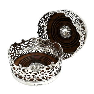 PAIR ANTIQUE VICTORIAN SILVER COASTERS / WINE BOTTLE: 1838 London A pair of magnificent Antique Solid Silver Wine Bottle Coasters embellished with an ornate pierced pattern around the tall sides of the Coaster. The rim of the coaster has an ornate