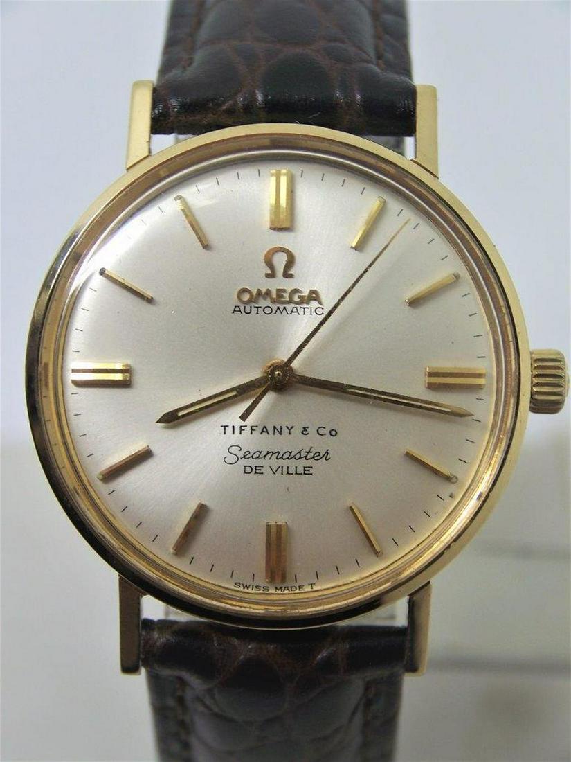 Vintage Solid 18k OMEGA SEAMASTER DeVILLE TIFFANY: Description Vintage Solid 18k OMEGA SEAMASTER De VILLE TIFFANY Automatic Watch 1960s Cal.550 in Excellent Condition This Mens Omega watch is Swiss made. Great present for yourself or someone you love