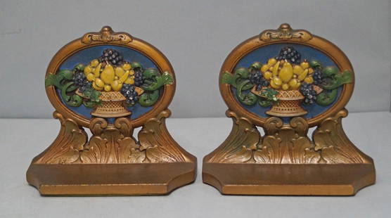 Fruit in Urn Cast Iron Bookends: Title: Fruit in Urn Cast Iron Bookends Date/Period: Circa 1920's. Dimension: 5 3/4" H. x 6 1/2" W. x 2 1/2" D. Provenance:A pair of Antique Cast Iron Assorted Fruit in Urn Bookends. Exceptional color,