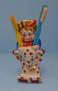 Vintage Child Riding ElephantToothbrush Holder: Title: Vintage Child Riding ElephantToothbrush HolderDate/Period: Circa 1930’s-40’sDimension: 6" tall x 3 1/4" wide x 2 3/8" deep.Provenance:A Vintage free standing or wall mount porcelain Child