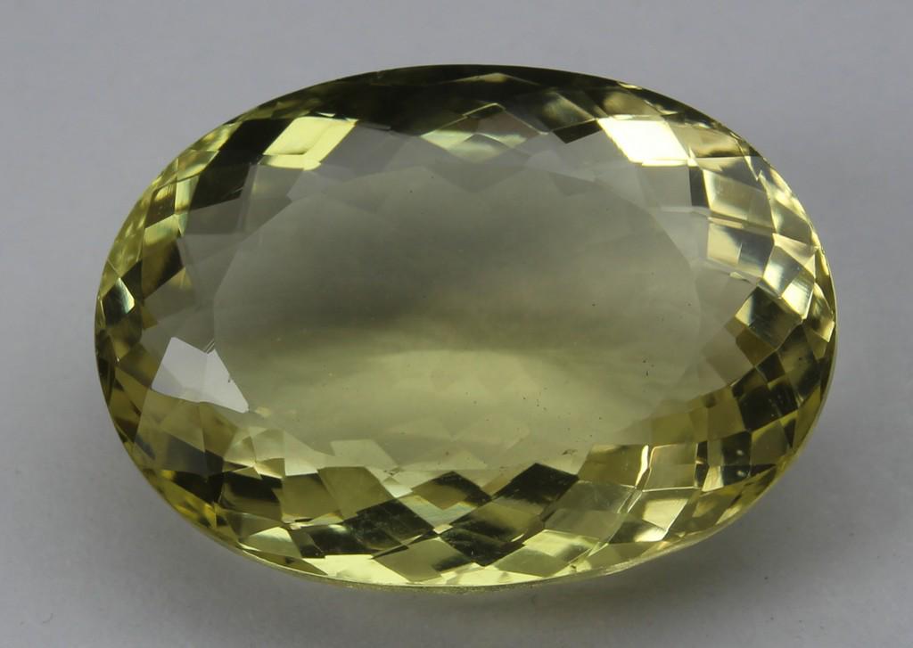 24.19 CT Natural Lemon Quartz: No Reserve! Title: 24.19 CT Natural Lemon Quartz Additional Information: Gemstone : Lemon QuartzOrigin : BrazilWeight in carats : 24.18Size : 22x16.5x9.5 mmShape : Oval CutColor : Greenish YellowClari