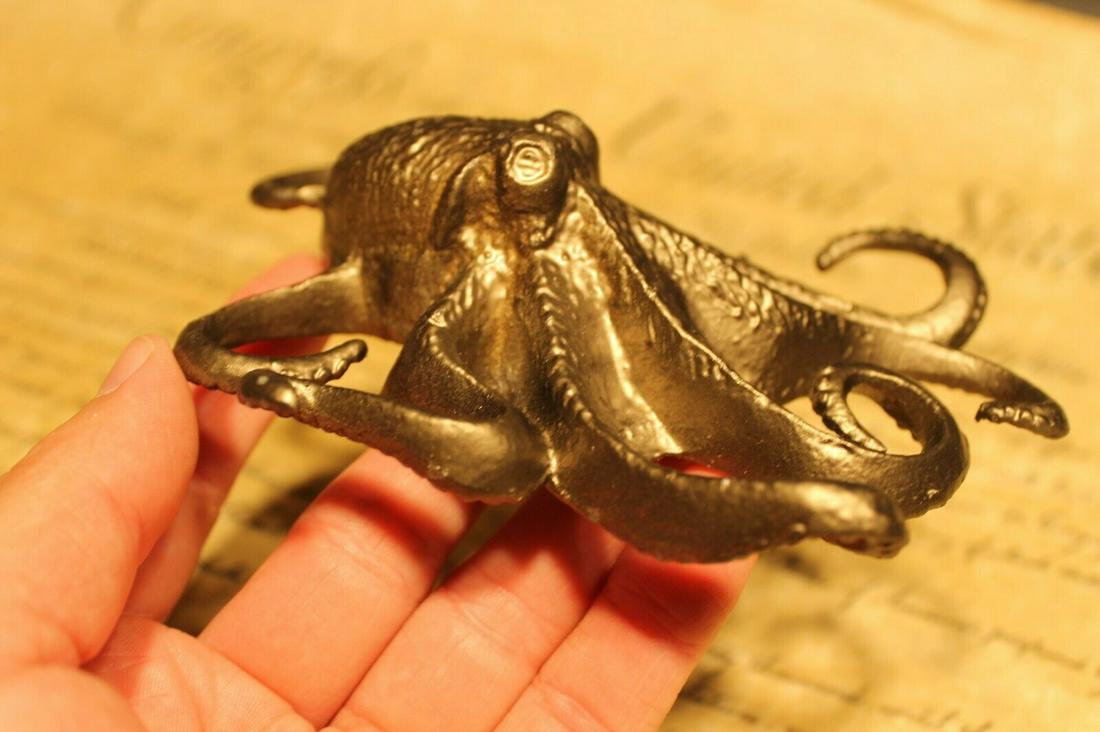 Brass Octopus Paperweight: 5 1/2" long x 4" Wide Very accurate and well made reproduction of an antique octopus paperweight. Darkened to look old. Certainly easy to wonder its age Reserve: $15.00 Shipping: Domestic: Flat-rate o