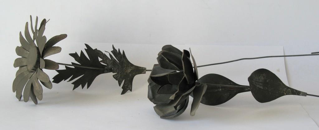 Pair of vintage tin flowers.: Title: Pair Of Vintage Tin Flowers Date/Period: 1930's or earlier Dimension: About 14Â” stem Provenance:Nice pair of tinsmith made flowers with excellent patina. A rose and a daisy. Shipping: Domes