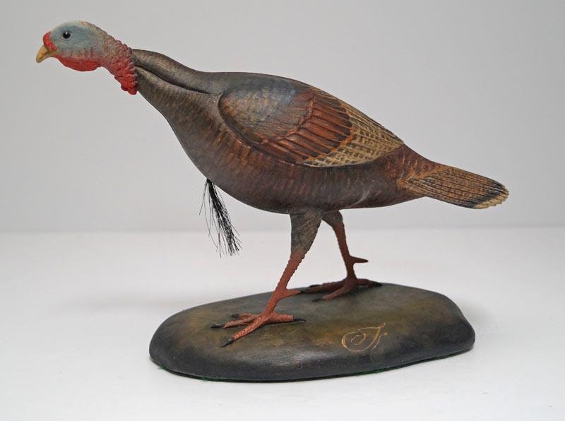 Turkey Wood Carving by Frank Finney: Title: Dimension: Turkey – 6 5/8” tall x 9” long x 2 ¾” wide. Base – 3 ¾” wide x 6 3/8” long. Provenance:Exquisite realistic wood carving of painted Turkey. Carved by noted carver and
