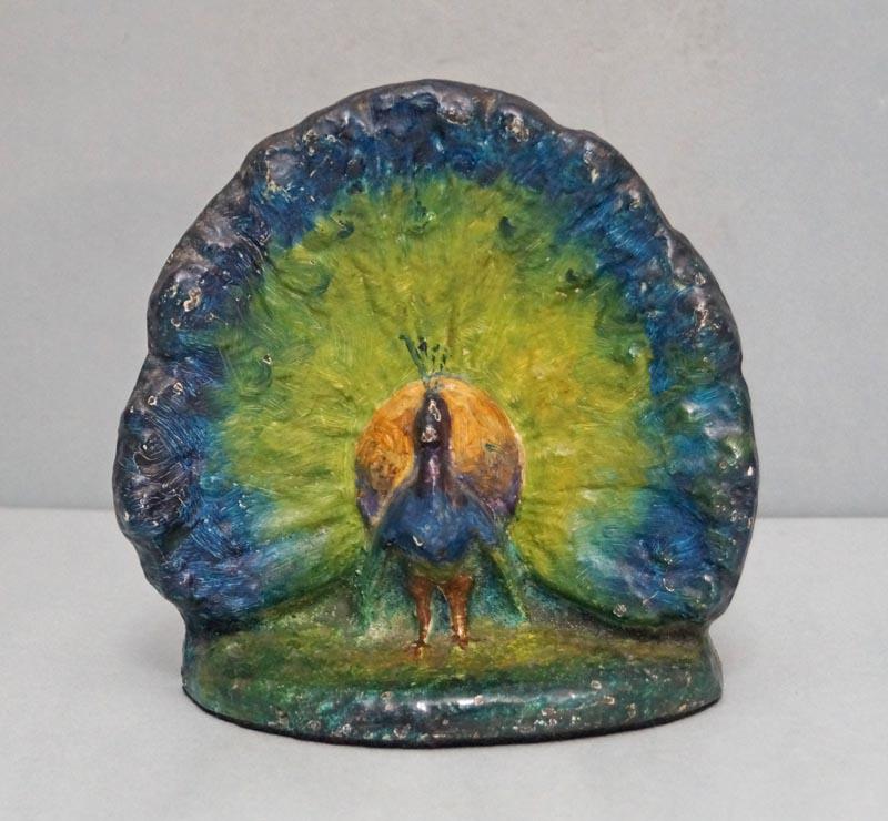Antique Peacock Bird Cast Iron Doorstop: Title: Antique Peacock Bird Cast Iron Doorstop Date/Period: Circa 1920's. Dimension: 6 1/4" tall x 6 1/2" wide. Provenance:An Antique Cast Iron Peacock with Opened Feathers. Doorstop in stunning array