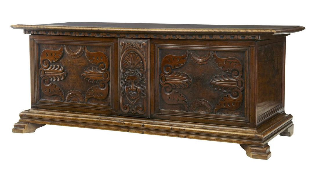 19TH CENTURY CARVED WALNUT COFFER CHEST: 19TH CENTURY CARVED WALNUT COFFER CHEST 19TH CENTURY FLEMISH WALNUT COFFER CIRCA 1870. BAROQUE INFLUENCED CARVING FEATURING A TRIBAL FACE TO THE FRONT, FLANKED EITHER SIDE BY CARVED PANELS IN THE SOLI