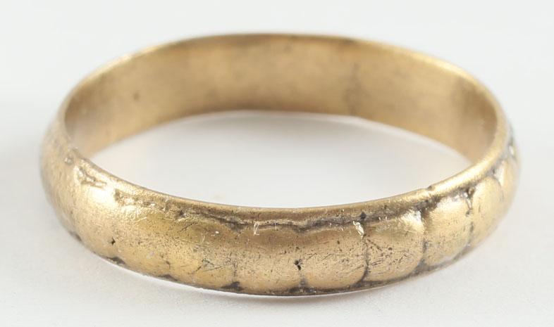 FINE VIKING WEDDING RING, 9TH-10TH CENTURY AD. SIZE 8: Bronze, originally gilt, size8 3/4. Medium width band, 3.9mm. Narrow edge beads flanking a central band of addorsed low domes, now with some wear from use.. The inside cleaned for modern wear. The 24 