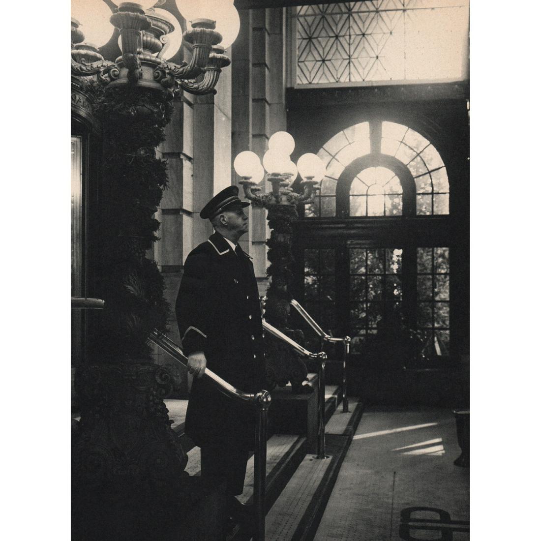 EVELYN HOFER - Doorman at The Plaza Hotel: Artist: EVELYN HOFER Print Title: Doorman at The Plaza Hotel, New York City Medium: Sheet-fed Gravure Printing Date: 1960's Printed in Switzerland Image Size: 11 x 8.25 inches Evelyn Hofer (1922-2009)