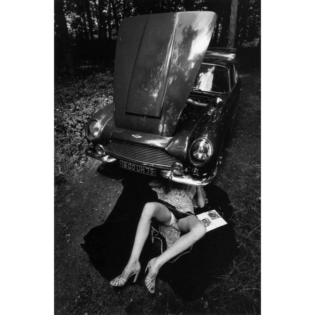 JEANLOUP SIEFF - Alone Under the Car, Paris 1975: Artist: JEANLOUP SIEFF Print Title: Alone Under the Car, Paris 1975 Medium: Glossy Photo-Lithograph Poster Printing location: Germany Printing Date: 1990's Image Size: 17 x 12 inches Jeanloup Sieff (1