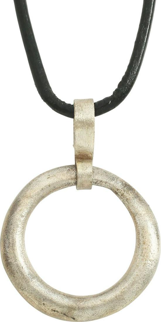 VIKING PROTECTIVE BROOCH 900-1050 AD.: Circular bronze, just under 1” of oval section with a ridged edge.. Surface lightly textured from burial. Worn in numbers on the surface of the jerkin, these small metal brooches provided a measure 