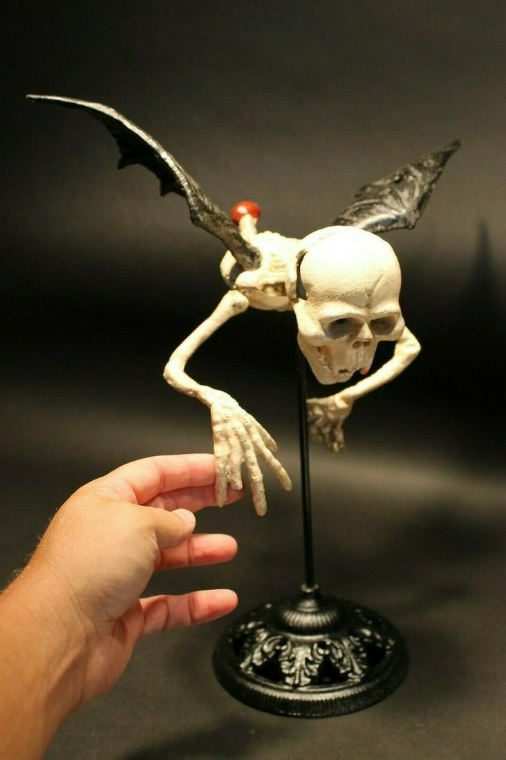 Cast Iron Flying Skeleton Halloween Decoration Statue: 16" Tall x 13" wide 5 lbs 6 oz Great reproduction cast iron flying skeleton. The arms and head on this piece are movable. Such a neat quality item. The pictures just do do it justice! Great for Hallow