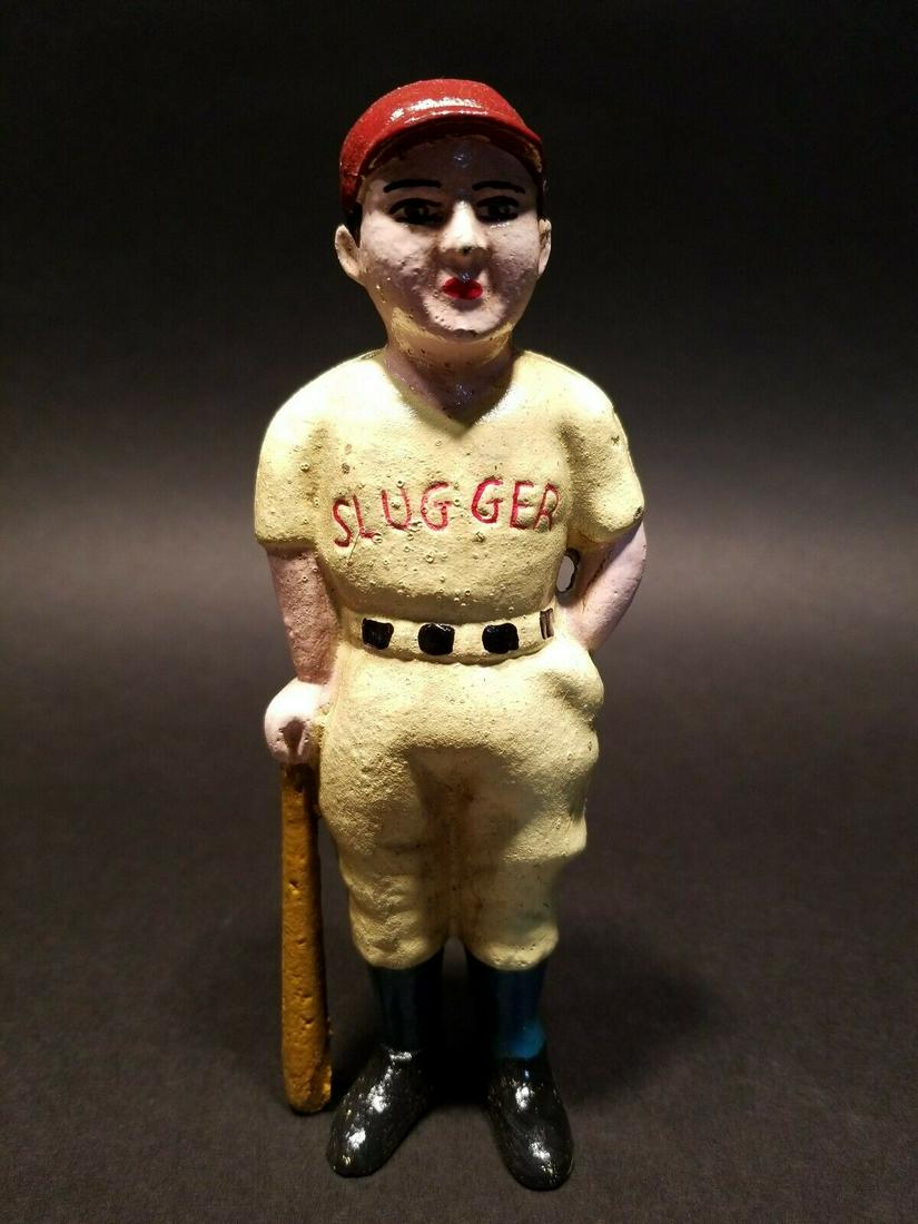 Cast Iron Slugger Coin Bank Baseball Player: 7" Tall x 3" Wide Wonderful reproduction hand painted cast iron "slugger" baseball player coin bank. This bank is said to be a reproduction, not sure when it was made. Please see the images for typica