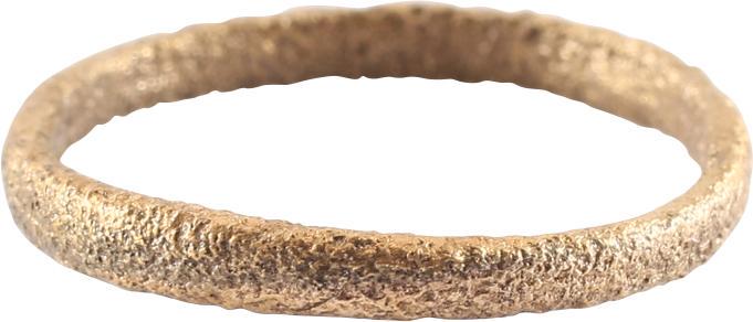 VIKING WOMAN’S WEDDING RING: 9th- 11th century AD. Gilt bronze, size 4 3/4. Narrow 2.0mm width band with a rounded face. Surface textured overall from burial. Vikings exchanged rings on the pommel of the groom’s sword. Professi