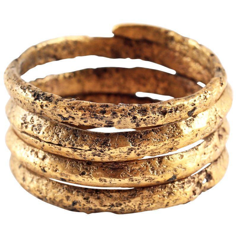 FINE VIKING COIL RING, 10th CENTURY AD. Size 10 3/4.: Gilt bronze. Size 10 3/4. Ridged face band in four full coils to 1/2” width. Textured from burial. Sound wearable condition and professionally refurbished with the gold surface restored. Gift boxed 
