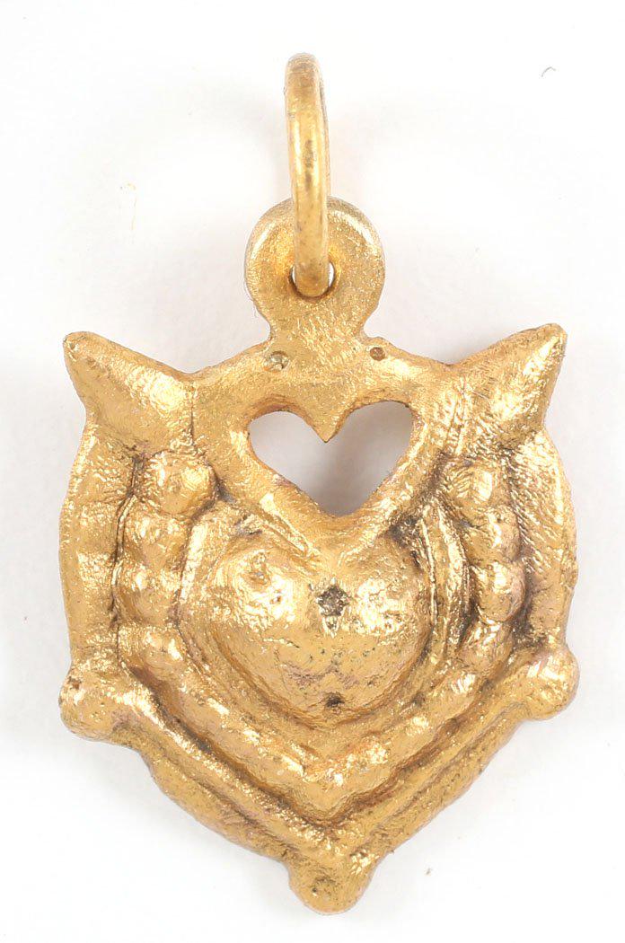 FINE VIKING HEART PENDANT 900-1050 AD: Over 7/8” height, with nubs at the sixth points. Raised rounded edge with depressed border. Central heart with a beaded border. The form of the heart is natural as in the body rather than stylized w