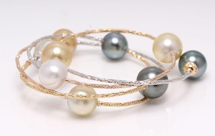 18 kt. Tricolour Gold - 10x11mm Tahitian and South Sea: This bracelet measures 55cm in total and wraps beautifully several times around the wrist. The bracelet contains 9 top quality high lustered South Sea and Tahitian Pearls, 10x11mm each in measurement.
