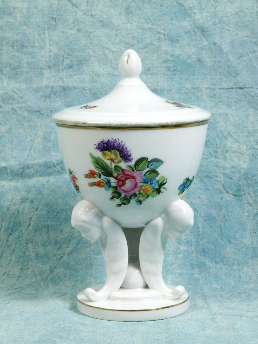Herend URN TRIPOD SALT SUGAR CELLAR Bonbon Dish Cherubs: This is a beautiful Vintage Cherubs footed and Covered Urn/TRIPOD SALT/SUGAR CELLAR or Bonbon Dish/Cup made by Herend in Hungary. The dish features a bouquet of flowers in front and scattered flowers.