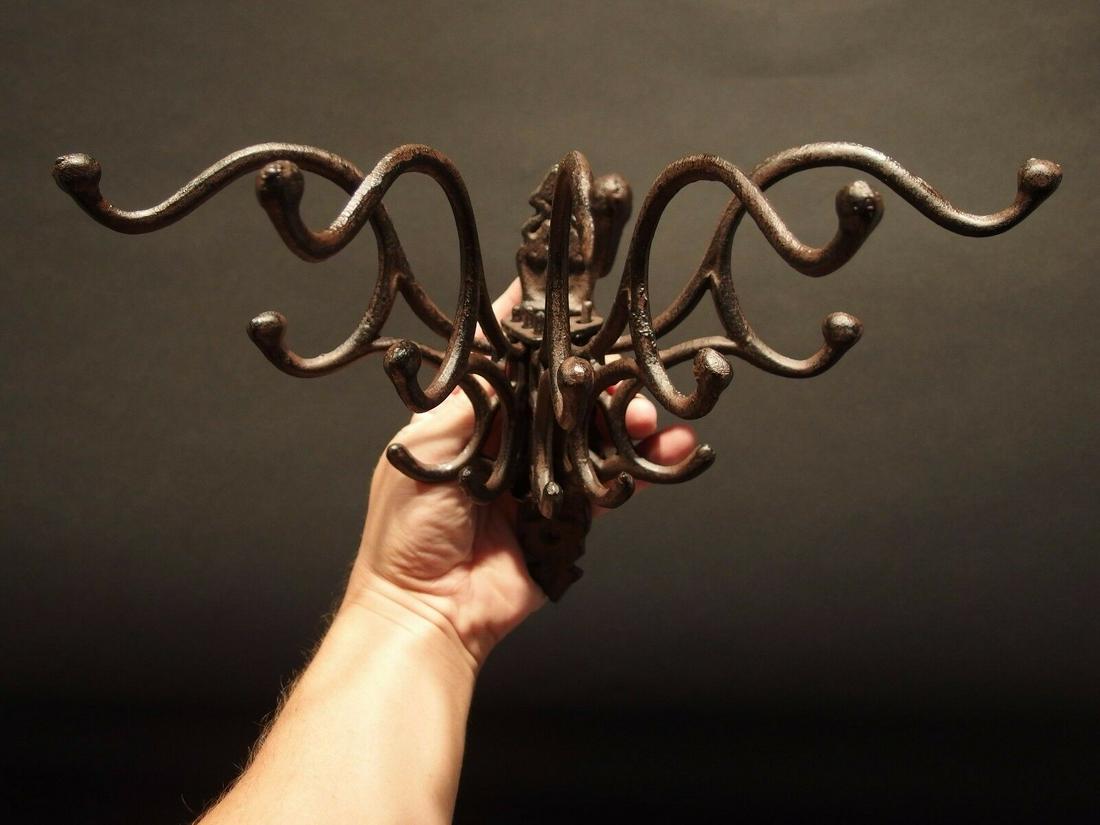 5 arm Cast Iron Swivel Wall Hook Coat Rack: (1) Hook 7" Tall.. 1 3/4" Wide 7 3/4" Extension Great reproduction sturdy iron wall hook cast from an antique. Notice the 5 folding arms Great textured black/brown/rust color powder coat... a very stu