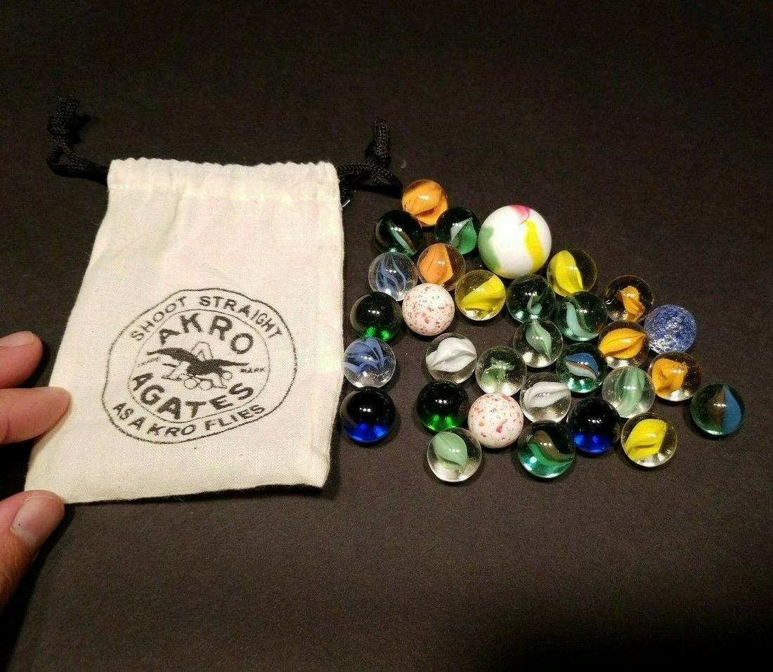 Akro Agates Marble Bag With Marbles: Wonderful reproduction Akro Agate cloth bag with marbles inside. Be sure to ask any questions you may have. Reserve: $10.00 Shipping: Domestic: Flat-rate of $6.00 to anywhere within the contiguous U.S