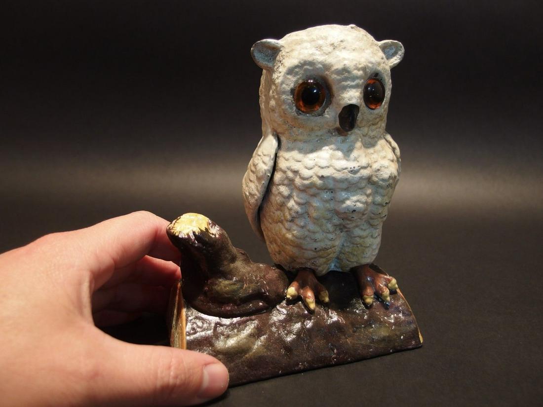Cast Iron Owl on Log Coin Bank Door Stop: 6 1/2" Tall x 5" long x 3 3/4" Wide 3 lbs 12oz A wonderful reproduction cast iron white owl on a log coin bank. This owl bank as you can see has a seam down the middle. It is somewhat hollow yet still