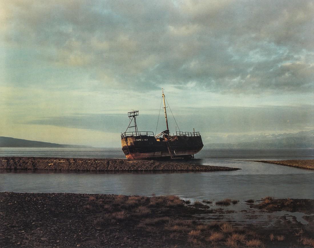 JOEL STERNFELD - Abandoned Freighter, Homer, Alaska: Artist: Joel Sternfeld Title: Abandoned Freighter, Homer, Alaska, 1984 Medium: Photo Litho, 1994, Italy Dimensions: 9.7x7.6" Heat Wax Mounted on 11x14" Conservation Board Joel Sternfeld (1944) is a fi