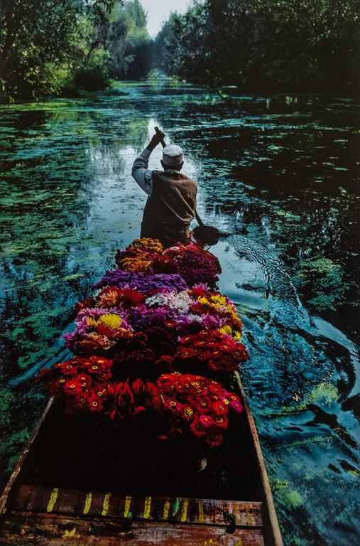 STEVE MCCURRY - Flower Seller, Dal Lake, Srinagar: Artist: Steve McCurry Title: Flower Seller, Dal Lake, Srinagar, Kashmir Medium: Photo Litho, 2012, Italy Dimensions: 9.45x14" Heat Wax Mounted on 14x18" Conservation Board Steve McCurry is an American