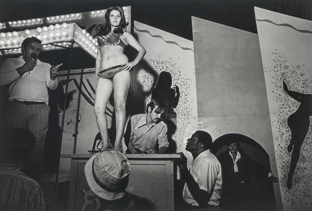 SUSAN MEISELAS - Lena on the Bally Box, Essex Junction: Artist: Susan Meiselas Title: Lena on the Bally Box, Essex Junction, VT 1973 Medium: Photo Litho, 2015, Spain Dimensions: 7x4.7" Heat Wax Mounted on 8.5x11" Conservation Board Susan Meiselas (1948) is