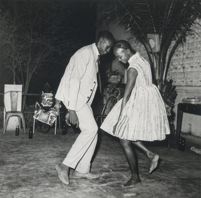 MALICK SIDIBE - Christmas Eve, Happy Club, 1963: Artist: Malick Sidibe Title: Christmas Eve, Happy Club, 1963 Medium: Photo Litho, 2015, Spain Dimensions: 6.2x6.1" Heat Wax Mounted on 8.5x11" Conservation Board Malick Sidibe (1935 - 2016) was a Mali