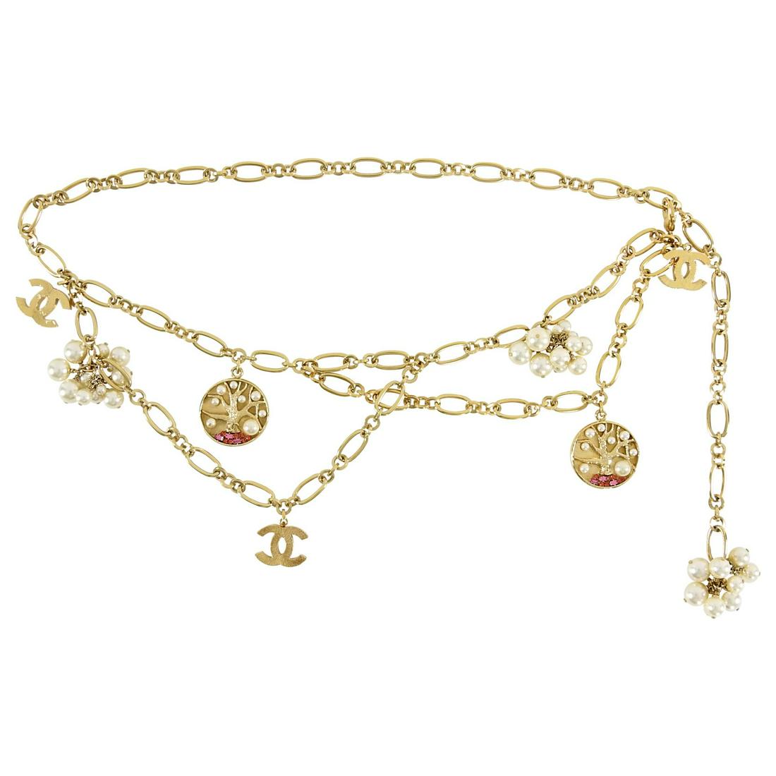 Chanel 07P Gold CC Pearl Tree Chain Belt: Chanel 07P Gold CC Pearl Tree Chain Belt. Goldtone metal layered chain belt with faux pearl clusters, CC logo pendant drops, and gold CC trees decorated with faux pearls and pink rhinestones. Measures