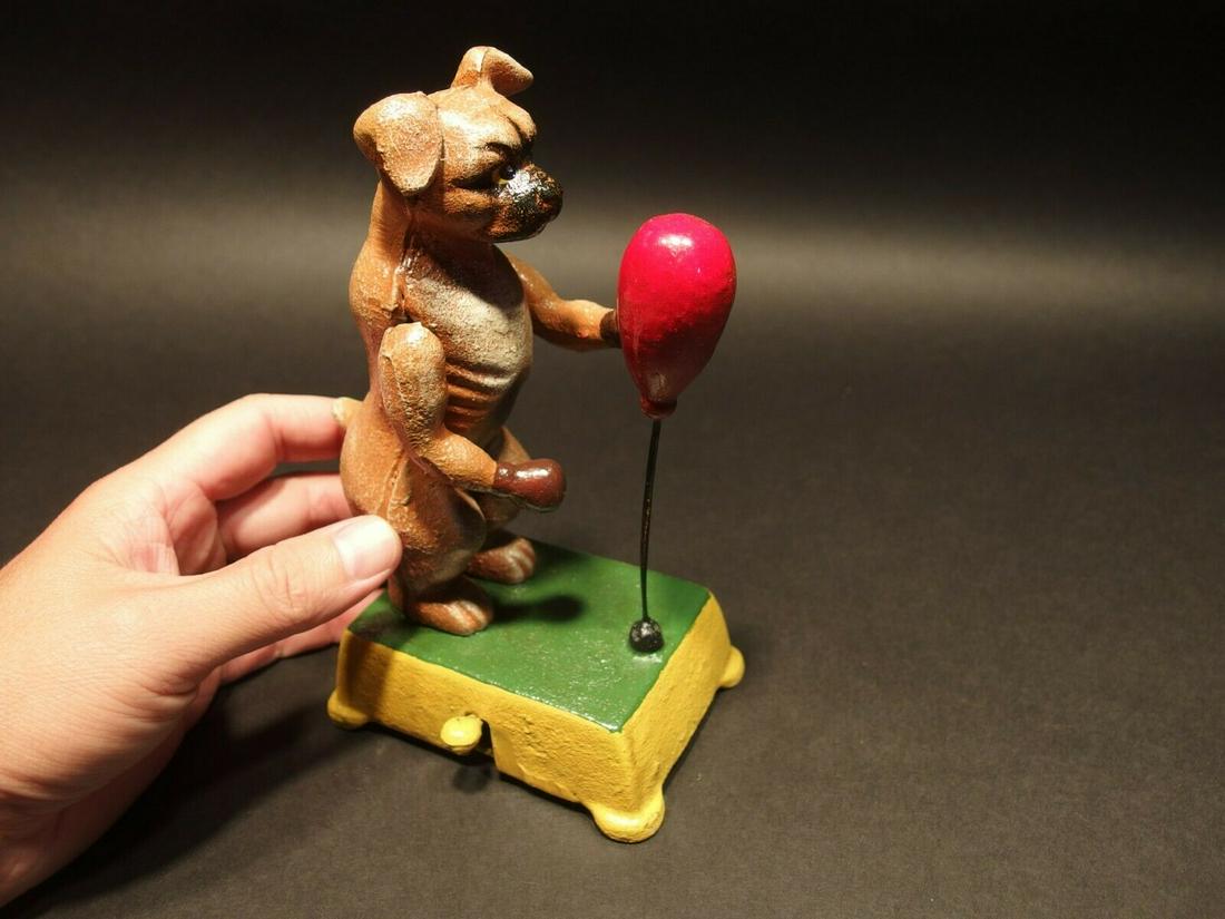Cast Iron Boxing Boxer Dog Mechanical Toy: 6 1/4" Tall x 4 1/2" long x 3" Wide 3lbs 7oz A wonderful reproduction cast iron collectible boxing dog toy. All hand painted. This cast iron toy as you can see operates by pushing down the lever. It w