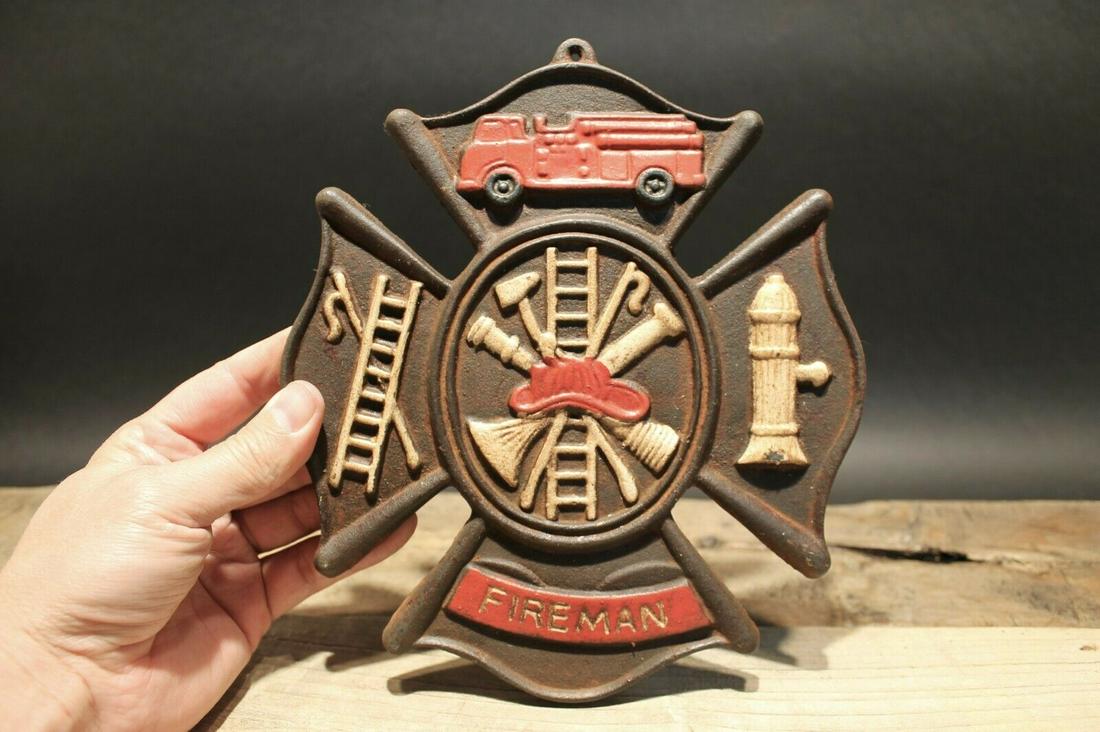 Cast Iron Fire Fighter Plaque Fire Mark Sign: 9" Tall x 7 3/4" Wide Well made reproduction cast iron Fire Fighter Fireman plaque. Be sure to see the pictures.. looks old but is actually fairly new.. Reserve: $30.00 Shipping: Domestic: Flat-rate o